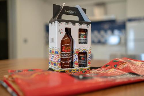 a bag of beer is sitting on a table at Sikelika Residence Sul Mare in Scoglitti