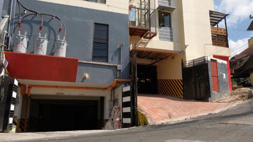 a building with a garage with several white gas turbines at Zukiya Residences Baguio in Baguio