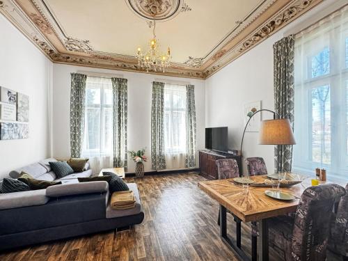 a living room with a couch and a table at Ferienwohnung Villa Nieske - Jugendstil Denkmal in Herzberg