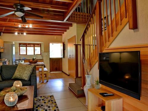 a living room with a large flat screen tv at Kruger Park Lodge - Modern Unit 225B in Hazyview
