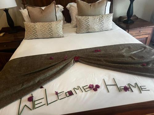 a bed with the words welcome home written on it at Kruger Park Lodge - Modern Unit 225B in Hazyview