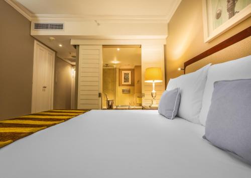 a bedroom with a large white bed in a room at Hemingways Hotel in East London