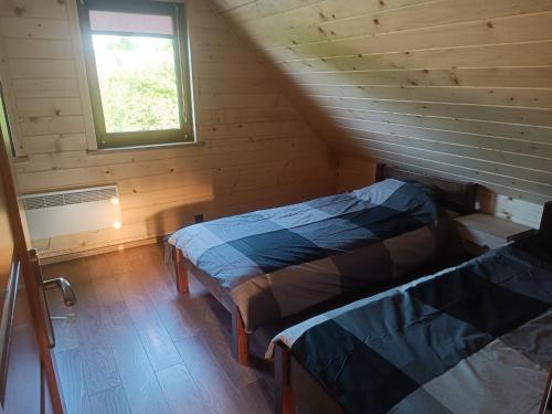 Krevet ili kreveti u jedinici u okviru objekta U Szwagra, domek całoroczny
