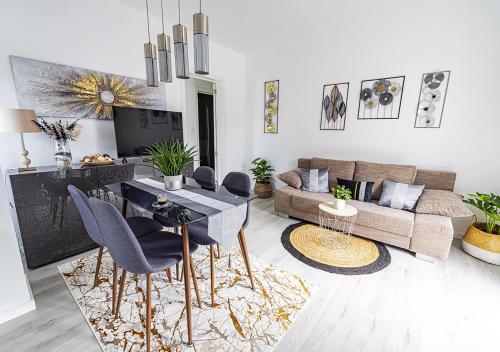 a living room with a couch and a table and chairs at Casa do Mar / Villa Eira Nova in Porto Covo