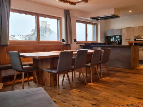 a kitchen with a large wooden table and chairs at Alpenzeit in Ladis