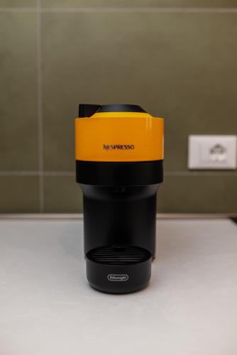 a coffee pot with a yellow top sitting on a counter at Ca' Marinaressa in Portogruaro