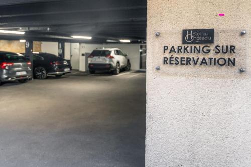 a parking garage with cars parked in it at Hôtel du Château Dinan - Originals Boutique in Dinan
