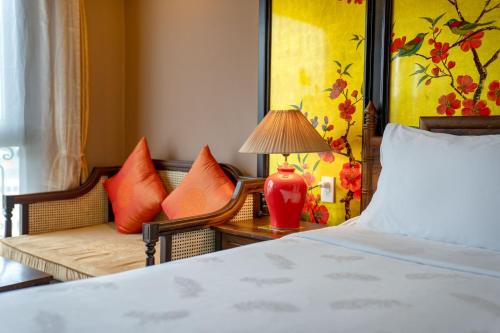 a bedroom with a bed and a couch at Indochine Cruise Lan Ha Bay in Ha Long