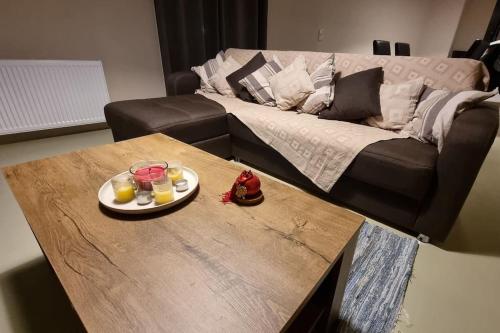 a coffee table with a plate of food and drinks on top at The Black Chestnut in Áyios Nikólaos
