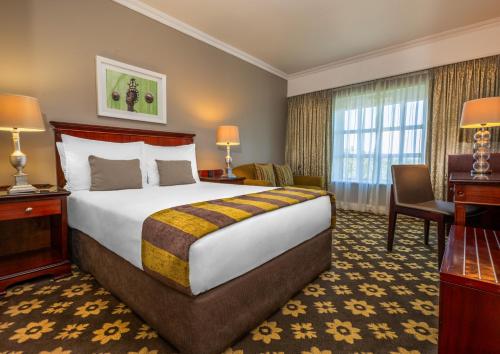 a hotel room with a bed and a desk at Hemingways Hotel in East London