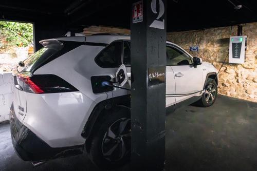a white car is parked in a garage at Hôtel du Château Dinan - Originals Boutique in Dinan