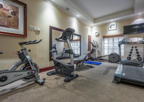 a gym with several exercise bikes and tread machines at Hemingways Hotel in East London