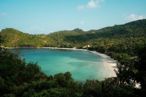 a view of a beach with trees and blue water at Panviman Resort Koh Phangan in Thong Nai Pan Noi
