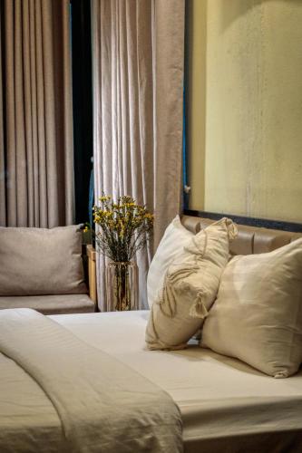 a bed with white sheets and pillows in a room at Hanoi Family Homestay in Hanoi