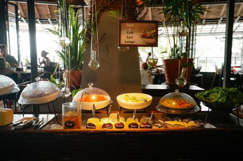 a buffet with different types of food on a table at Panviman Resort Koh Phangan in Thong Nai Pan Noi