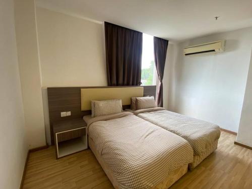 a bedroom with a large bed and a window at Entire Room in Ayer Keroh in Ayer Keroh