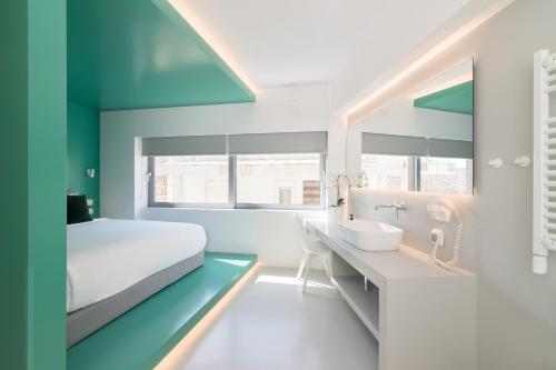- une chambre avec un lit et une salle de bains pourvue d'un lavabo dans l'établissement Athens Color Cube, à Athènes