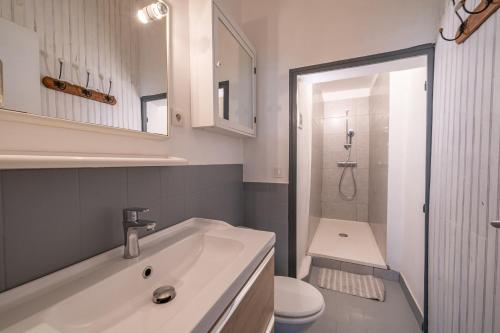 a white bathroom with a sink and a toilet at Studio - Coeur d'Aix en Provence - Calme - Sans Vis-à-vis in Aix-en-Provence