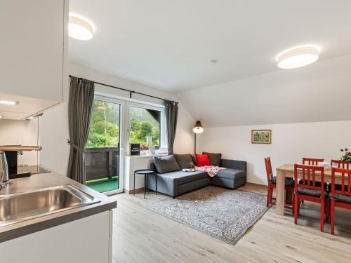 a kitchen and living room with a couch and a table at Spacious Apartment in Katschberg in Sankt Michael im Lungau