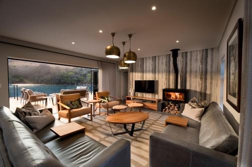 a living room with a couch and a fireplace at Cradle Boutique Hotel in Lanseria