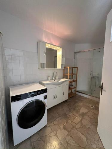 a kitchen with a washing machine and a sink at Sunset View in Hydra