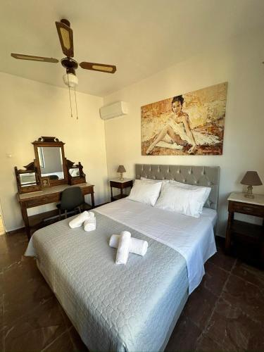a bedroom with a bed with two towels on it at Sunset View in Hydra