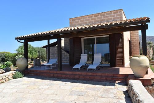 a patio with chairs and a gazebo at Villa Casa Onde in Favignana