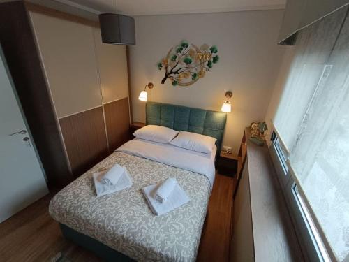 a bedroom with a bed with two pillows on it at Sotherm apartment in Thermi