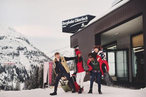 a group of women posing in front of a building at Burg Hotel Oberlech in Lech am Arlberg