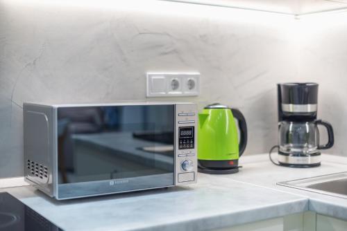 a microwave oven sitting on a kitchen counter at Kastela's Harbor Retreat with Jacuzzi in Piraeus
