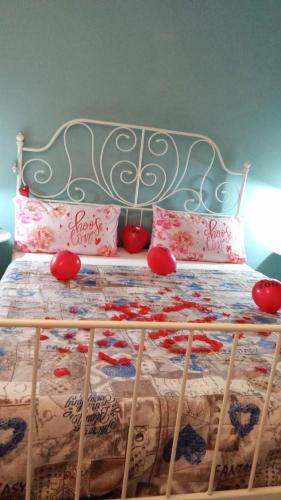 a bed with a metal frame and red pillows on it at A due Passi dalla Stazione e dal Centro in Novara
