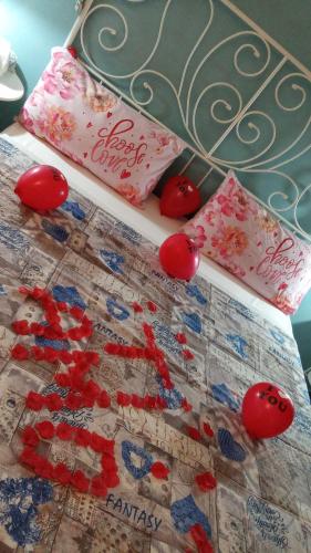 a bed with a quilt with red cherries on it at A due Passi dalla Stazione e dal Centro in Novara