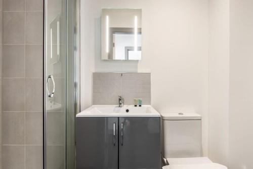 a bathroom with a sink and a shower at Lovely 1 Bedroom Apartment in Central Doncaster in Doncaster