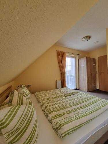 a bedroom with two beds and a window at Pension Schmidt Bad Kösen in Bad Kösen