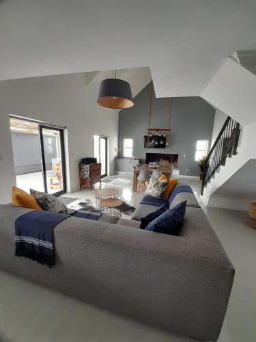 a large bed in a living room with a couch at C-Rock Holiday Home Jacobs Bay in Jacobs Bay