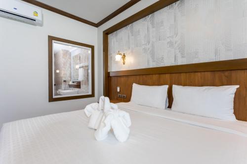 Postel nebo postele na pokoji v ubytování Le Erawan Phang Nga Hotel