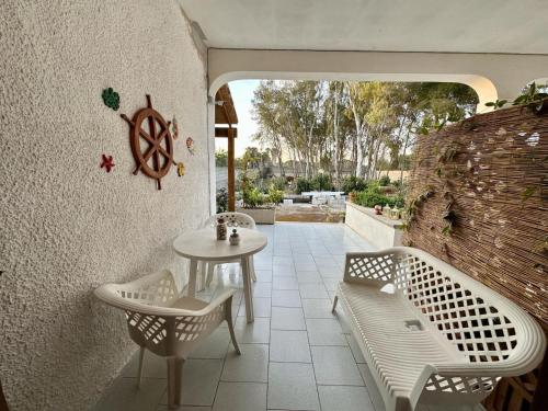 a patio with a table and two chairs and a table at Poesia del Salento in Roca Vecchia