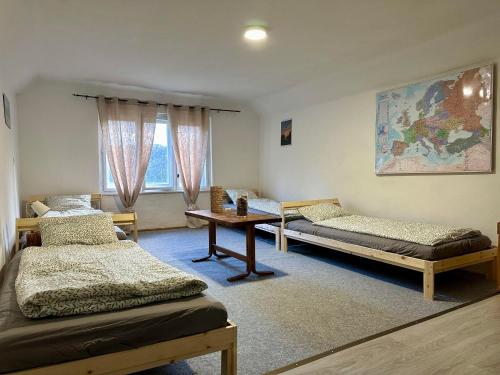 um quarto com duas camas e uma mesa em Rakousy22 em Rakousy