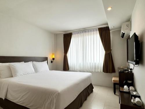 a hotel room with a bed and a television at Pas Cher Hotel de Bangkok in Bangkok
