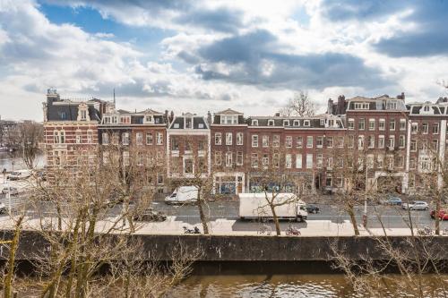 a view of a city with a bridge and buildings at Amstel Corner Hotel in Amsterdam