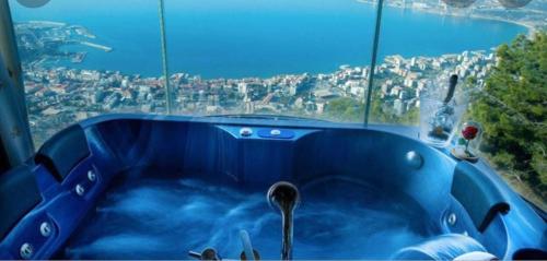 a blue tub in front of a large window at Bay Lodge Boutique Hotel in Jounieh