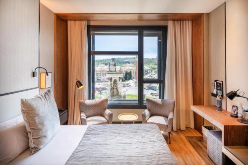 a hotel room with a bed and a window at Catalonia Barcelona Plaza in Barcelona