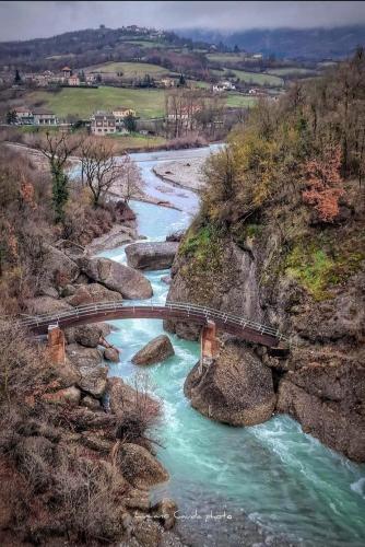 a bridge over a river with a train track at La Casa della Lavanda in Borgo Adorno