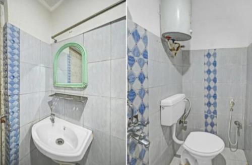 a bathroom with a white toilet and a sink at Hotel Shree Bhumi Puri - 100 Meters From Sea Beach - Best Seller in Puri