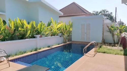 a swimming pool in front of a house at Phuket.Rent in Ban Klang