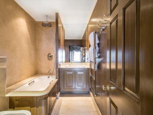 a bathroom with a sink and a tub and a toilet at San Domenico House in London