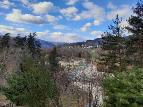 a view of a valley with trees and a river at Camping La Douce Ardèche in Désaignes