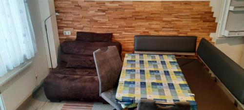 Zimmer mit einem Sofa, einem Tisch und einem Stuhl in der Unterkunft Ferienwohnungen Fryba in Bad Kleinkirchheim