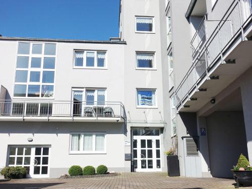 a white apartment building with a balcony at Apartment with Balcony near the Luxembourg s Border in Bollendorf