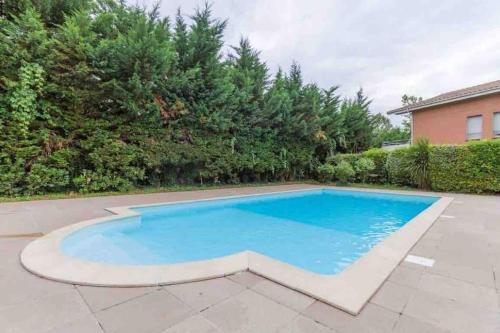 a swimming pool in a yard with trees at *T2*Vue Garonne*Piscine*Garage* in Toulouse
